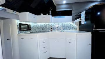 Fridge, microwave, stovetop, coffee/tea maker