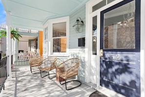 Step out onto the porch and enjoy the fresh air from the comfort of two wicker chairs.
