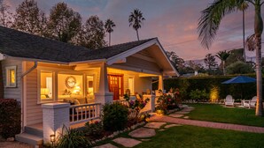 A house with a porch, a front door, and a small garden with stepping stones and plants. - Montecito Craftsman | Walk to Beach, Hot Tub, Bikes, Game Room & EV Charging (Montecito)