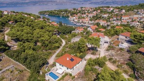 A coastal residential area with houses, a swimming pool, and a marina.