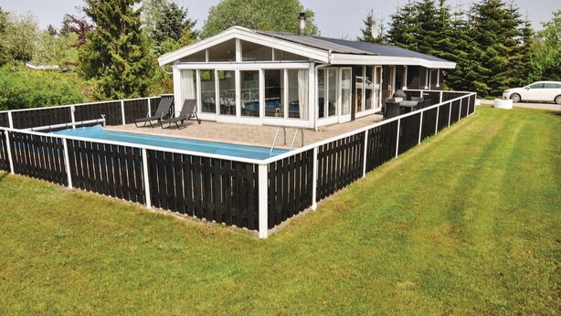 A modern house with a covered patio, a swimming pool, and a fenced backyard. - Stunning home in Middelfart with sauna (Middelfart)