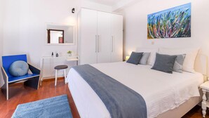 A bedroom with a large bed, a desk, a chair, and a wardrobe. - Awesome home in Podstrana (Podstrana)