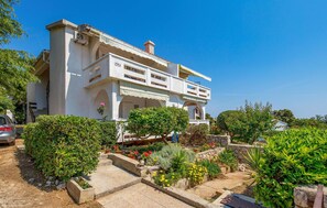 Stunning two-story residence with a balcony and beautifully maintained garden.