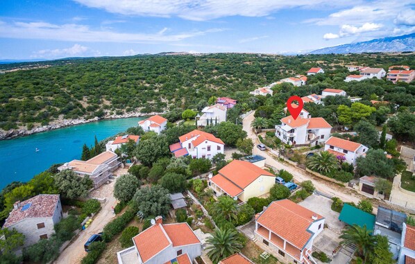 Stunning coastal homes surrounded by lush greenery and a serene sea view.