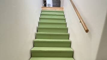 A staircase with green steps leading to a landing.