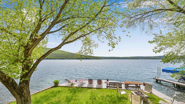 A lakeside deck with outdoor seating and a dock extending into the water. - Loon Landing - Fisherman's Paradise on West Shore of Keuka Lake (Hammondsport)
