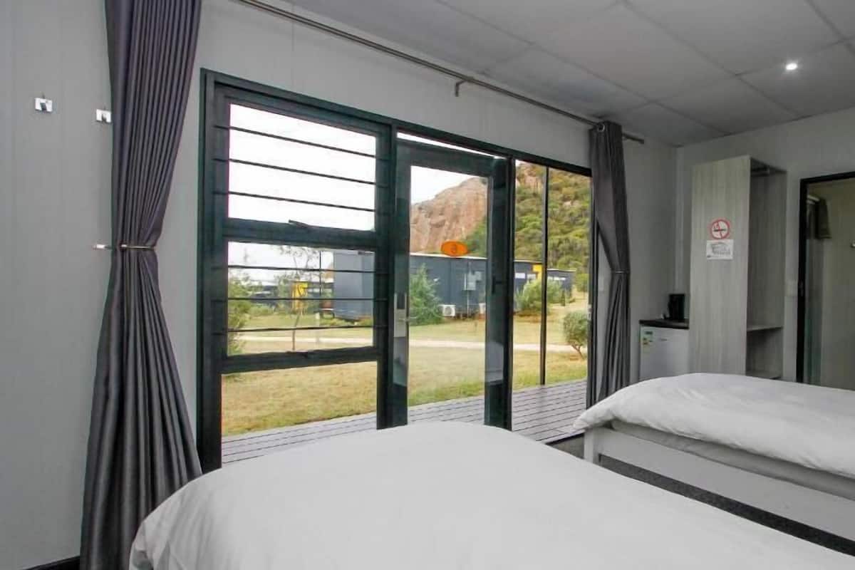 Minibar, desk, laptop workspace, bed sheets