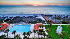 A resort with a swimming pool, beach access, and a view of the ocean at sunset. - Regatta Beach Club C713 '90 day min stay with 2 week lead time' (Clearwater Beach)