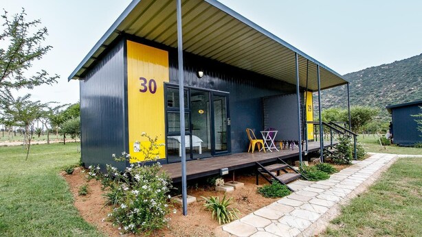 A modern building with a flat roof and a covered porch.