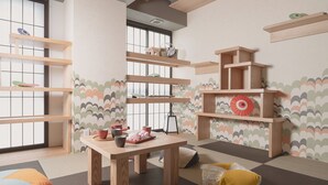 A room with tatami flooring, a low wooden table, and a window with a view. Shelves are mounted on the wall, and there are cushions on the floor. - MIMARU SUITES Kyoto Central (Kyoto)