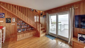 A wooden staircase leading to a balcony with a view of the sea. - Blue Oyster - Ocracoke Island (Ocracoke)
