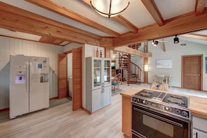 Enjoy cooking and dining in this open-plan kitchen and dining area with a modern stove and oven.