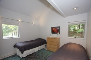 A bedroom with two beds, a dresser, and two windows. - Modern Lake House on Secluded Cove with Private Peninsula  (Enfield)