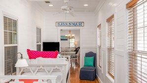 A room with a bed, a chair, a table, and a sign that reads "SAVANNAH". - Contemporary Beach Home Near Back River for the Whole Crew by Tybee Cottages (Tybee Island)