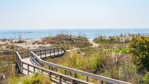 A wooden boardwalk leading to a beach with clear skies. - Oceanfront Wild Dunes villa-beach access, community pool & screened porch! (Isle of Palms)