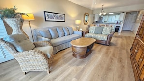 A living room with wicker furniture, a sofa, a coffee table, and a ceiling fan. - Sandy Key 231:  3 BR / 2 BA Gulf Front Condo in Perdido Key, FL  Sleeps 8 (Pensacola)