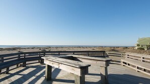 A wooden deck with a bench overlooking a beach. - Shipwatch A 203: Beautiful Wild Dunes Condo with Ocean Views (Isle of Palms)