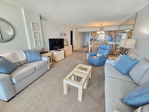 A living room with two sofas, a television, and a coffee table.