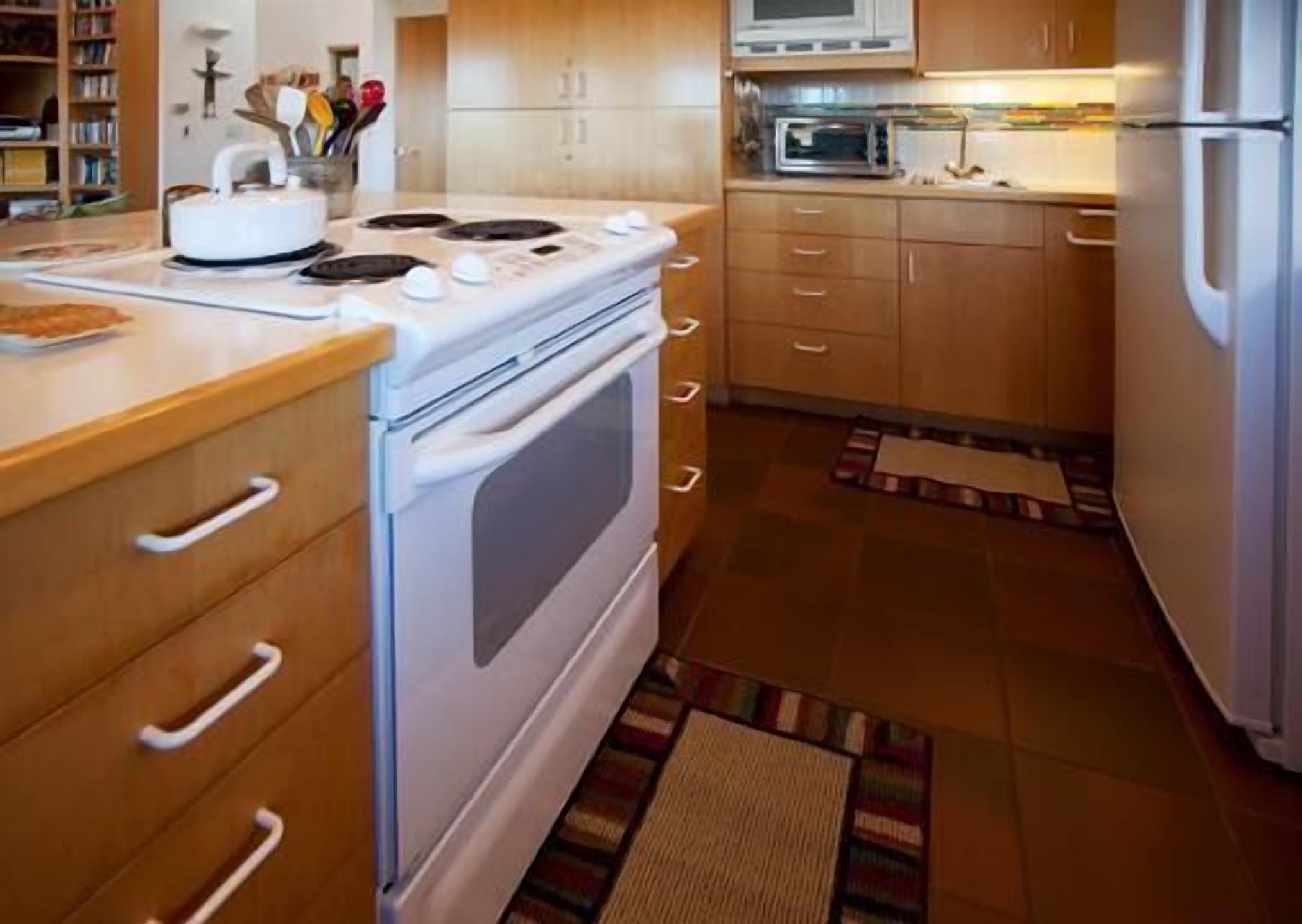A kitchen with a stove, oven, microwave, and refrigerator.