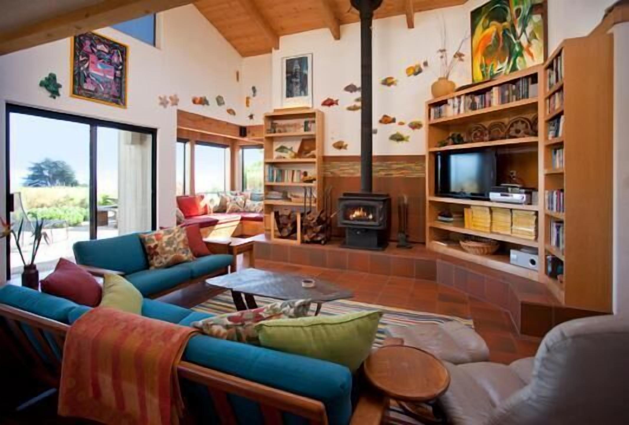 A cozy living room with a fireplace, comfortable seating, and a television.