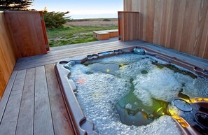 A hot tub on a wooden deck with a view of the beach. - Horizon Reach - Black Point Beach Views (Sea Ranch)