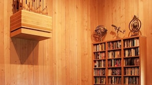 A wooden interior with a bookshelf and a decorative metal object.