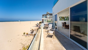 A modern building with a balcony overlooking a beach. - 3525O - Big Blue Beauty: 3  BR, 5  BA House in Oxnard, Sleeps 6 (Oxnard)