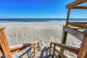 A wooden staircase leading to a sandy beach with a clear view of the ocean. - Cloud 9 - Three Bedroom, Two Bath Oceanfront House (Garden City Beach)