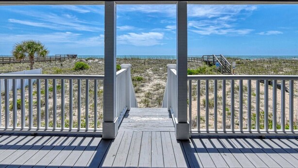 A wooden deck with white railings leading to a beach view. - Love's A Beach - 5 Bedroom. 4 Bathroom, Oceanfront Dog Friendly Home (Garden City Beach)