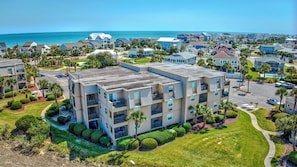 A multi-story hotel with balconies, a swimming pool, and a view of the ocean. - Inlet Pointe 29 Walk to beach in 2 minutes. Enjoy the pool and floating dock. (Garden City Beach)