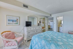 A bedroom with a bed, dresser, chair, and a painting on the wall. - Atalaya Tower 903 - Three Bedroom, Two Bath Condo (Garden City Beach)