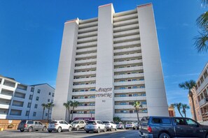 A high-rise building with multiple balconies, labeled 'Avalon Towers 912.'