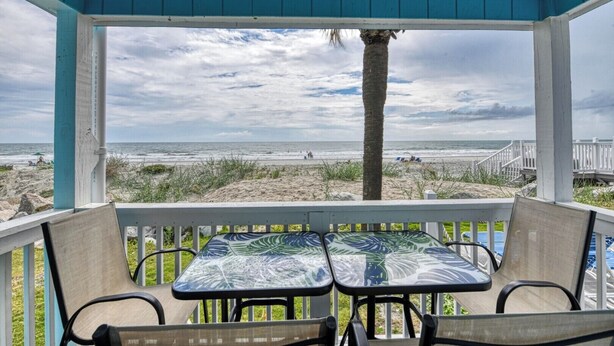 A covered outdoor seating area with a view of the beach and ocean. - Beach House 105 - Two Bedroom, Two Bath Updated Beach Condo (Garden City Beach)