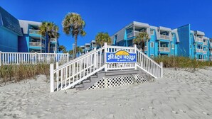 A beachfront hotel with a sign reading "The Beach House at Garden City." - Beach House 110, two-bedroom, two-bath ocean-view condo (Garden City Beach)