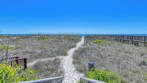 A beach path leading to the ocean with a wooden boardwalk and a small structure. - Compass Rose 32, three-bedroom, two-bath oceanfront condo, Wi-Fi (Garden City Beach)