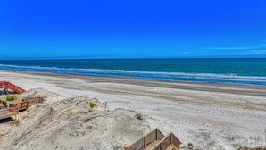 A beach with wooden walkways and a clear view of the ocean. - Doctor's RX - Six Bedroom, Six Bath, Oceanfront Duplex with Private Pool (Myrtle Beach)