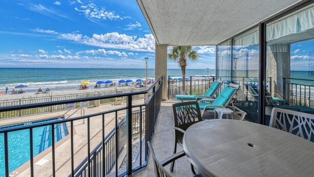 A balcony with a view of the beach and ocean. - Surfmaster 103 - Three-bedroom, three-bath first-floor oceanfront condo (Garden City Beach)