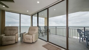 A balcony with a view of the sea, leather chairs, and a small table. - Surfmaster 1108 - Three-bedroom, three-bath oceanfront condo (Garden City Beach)