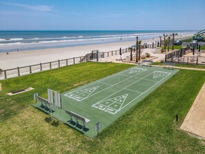 A green shuffleboard court with a view of the beach and ocean. - Watch the sunrise over the No Drive Beach in NSB! (New Smyrna Beach)