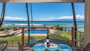 A balcony with a view of a swimming pool and the ocean. - Top Floor! Direct Ocean View! Vaulted Ceilings! Winter Spec! #218 (Lahaina)