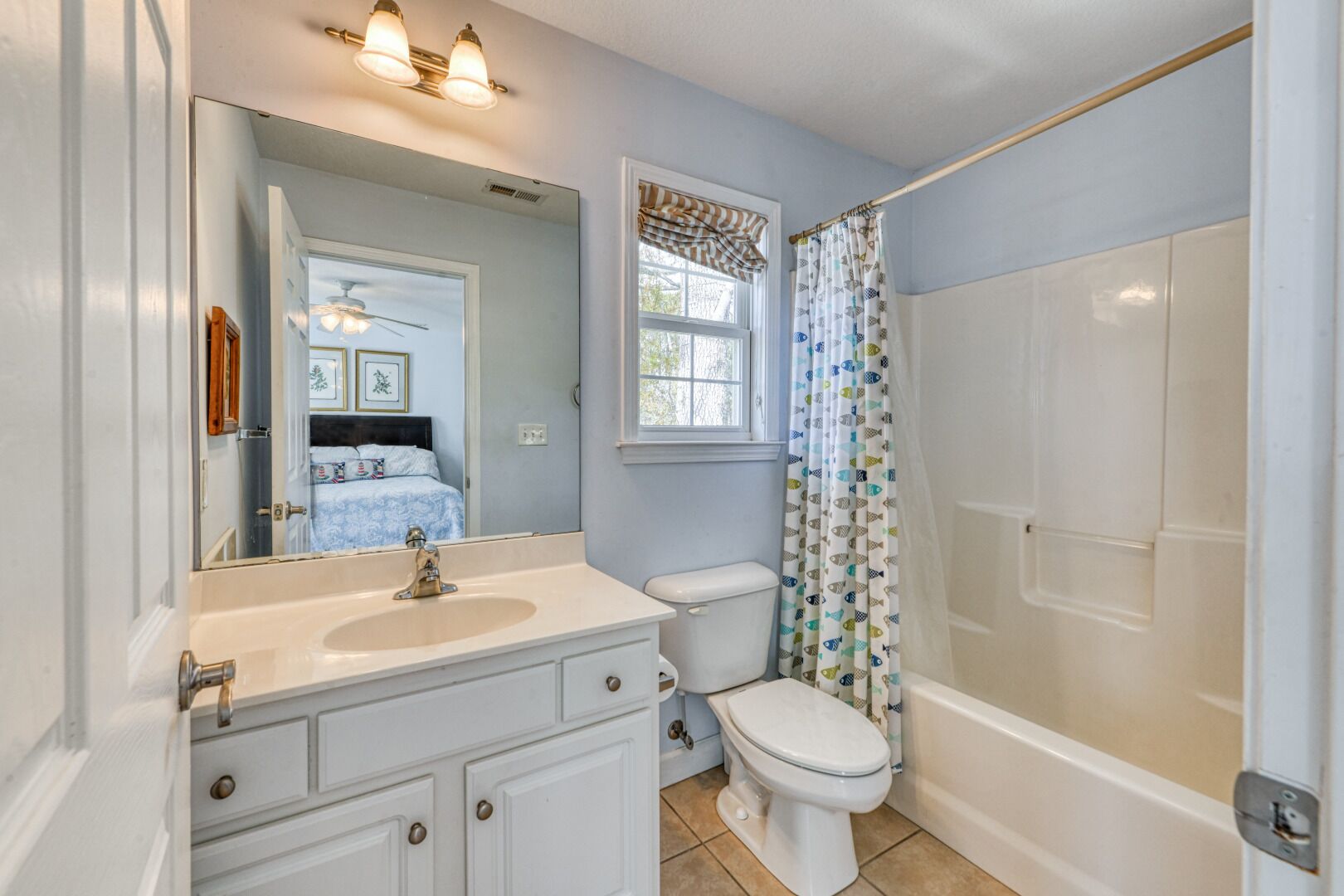 A bathroom with a sink, toilet, and shower.