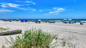 A beach with umbrellas and people relaxing. - Sea Watch VIII 103 - Two Bedroom, One Bath Oceanfront Condo (Garden City Beach)