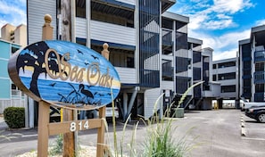 A multi-story building with a sign reading 'Sea Docks' and the number '814' indicating the address.