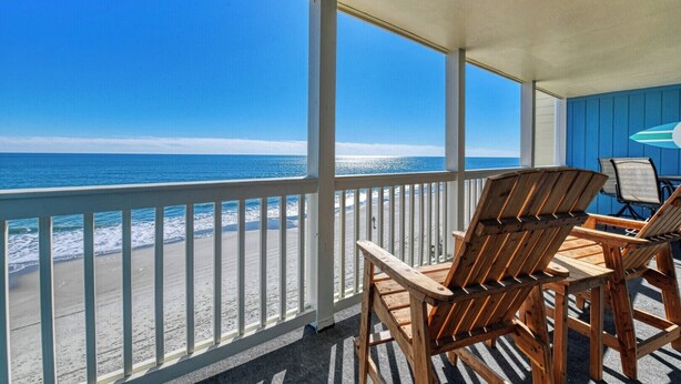 A covered outdoor seating area with a view of the beach and ocean. - Seasider 302 - Two-bedroom, Two & 1/2 Bath Oceanfront Condo (Garden City Beach)