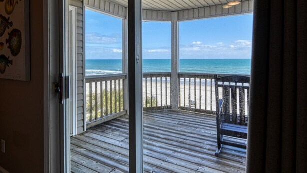 A wooden deck with a view of the beach and ocean. - T's Treasure's - Eight-bedroom, eight-bath oceanfront duplex w/ pool (Surfside Beach)