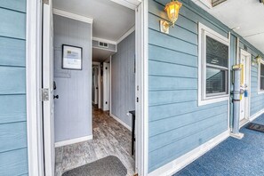 A house with a front door, a hallway, and a blue exterior. - Duneside III 304, Oceanfront Condo close to Garden City Pier (Garden City Beach)