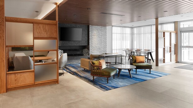 A modern living room with a TV, sofa, and dining area.