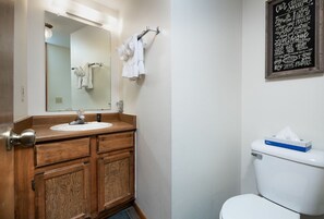 Enjoy a refreshing bathroom experience with a vanity, mirror, sink, and toilet.