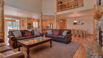 Télévision, cheminée, lecteur de DVD, livres