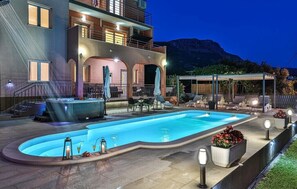 A two-story building with a swimming pool, outdoor seating, and a hot tub. - Villa Lioness in Kastel Luksic, playground & pool (Kastel Luksic)